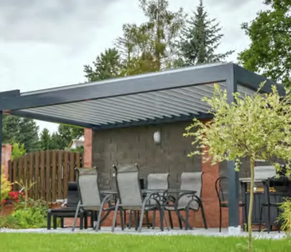 Freestanding louvered pergola with open louvres over backyard patio dining set