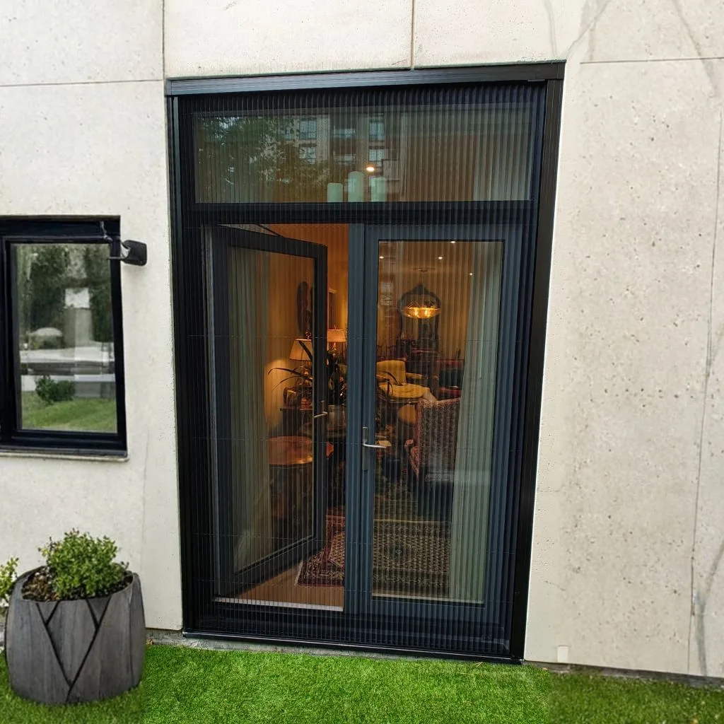 Dark mesh vertical bug door screen covering open double doors on patio