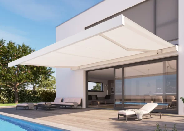 White retractable awning extended over pool deck beside sliding glass doors